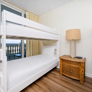 The guest suite's twin bunk beds offer restful spots where you can hear distant coast sounds through the balcony door