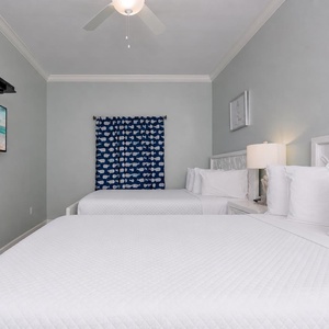 This guest suite with two queens welcomes you to rest deeply after a day full of family fun and coastal adventures