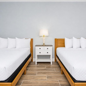 Rest peacefully in this guest room featuring two comfortable queen beds and a stylish nightstand with a lamp