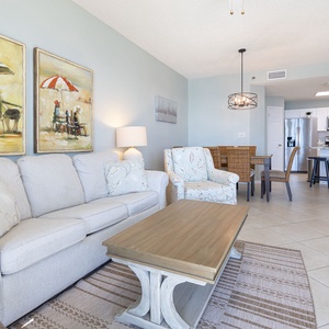 Relax on the comfortable sofa with queen sleeper, surrounded by beach art and a welcoming dining area