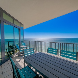 Experience stunning views from the spacious balcony, featuring a dining table perfect for gatherings