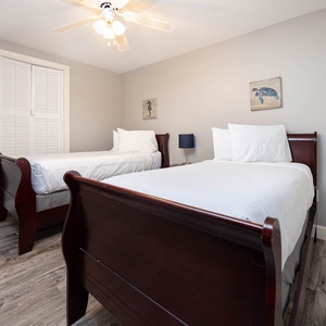 Rest comfortably in this welcoming guest bedroom featuring two twin beds, soft linens, and charming coastal decor