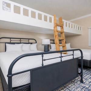 Sleep comfortably in this cozy bunk room with two queen beds and a lofted area with two twin beds