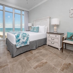 Wake to gulf light streaming through tall windows and step to the glass to gaze at the shore from this queen guest suite
