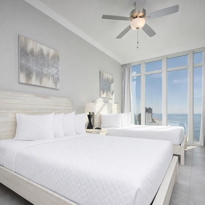 Awaken to a colorful sunrise in this queen guest suite and get ready for a beach day