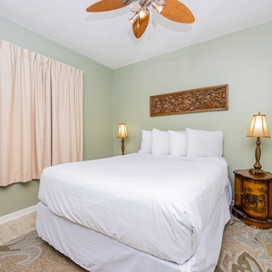 Rest comfortably in this inviting guest room featuring a queen bed, decorative accents, and soft lighting for a restful stay