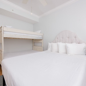 Guest room creating the perfect space for family to find their cozy retreat with a double bed and twin bunk