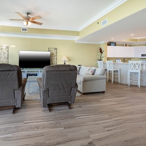 Unwind in cozy chairs as you enjoy movies together, soaking in the beach vibe from your inviting living space