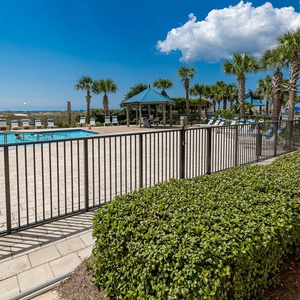 Enjoy a relaxing day in the sun on the outdoor patio with the pool and beach just steps away