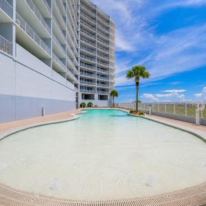Experience this gradual entry pool surrounded by palm trees and a stunning view just steps away from your rental retreat