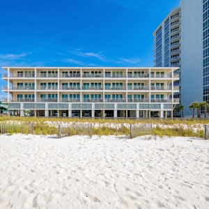Experience a beachfront vacation at this stylish rental with palm trees and spacious balconies, Sea Glass in Gulf Shores