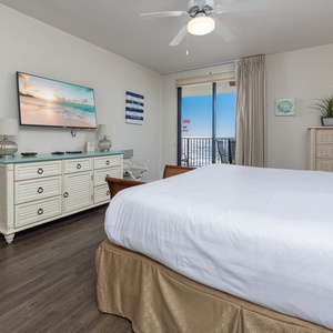 Relax in this inviting master bedroom featuring a king bed, a large TV, and easy access to a balcony with beautiful views