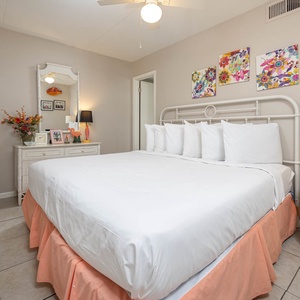 This inviting bedroom features a comfortable bed, stylish decor, and a charming seating area for relaxation