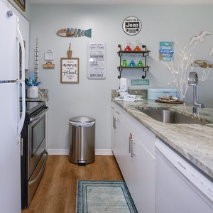 This kitchen features a sleek design and colorful decor creating a cheerful cooking space