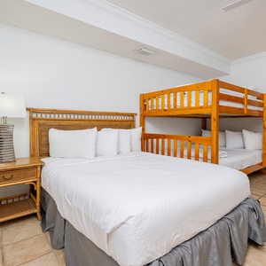 Enjoy cozy nights in this guest room, with a cozy queen bed and a playful bunk with double beds