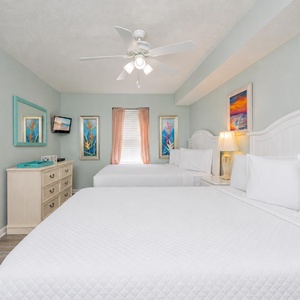 This guest suite with two full beds invites restful nights surrounded by tranquil coastal artwork and soft linens