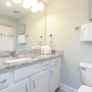 Freshen up in this guest bath in the relaxing shower or soothing tub before an exciting beach day