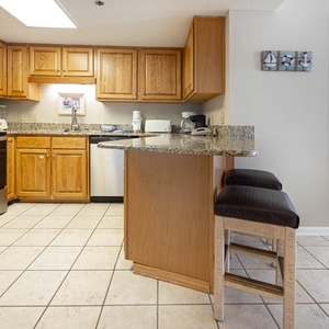 Cook and gather in this kitchen, featuring wooden cabinets and a breakfast bar
