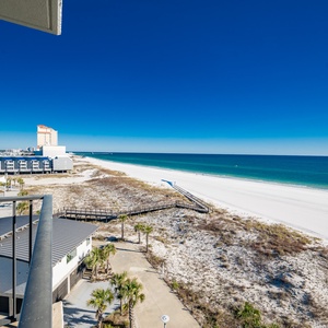 Gaze at the expansive coastline and tranquil waters from your inviting balcony space, perfect for relaxation