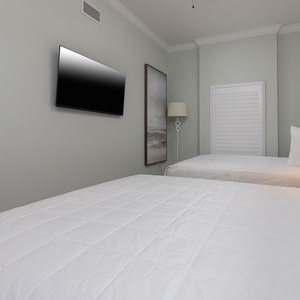 Lie back on soft bedding, play favorites on the TV, and unwind under gentle lamplight in this queen guest suite