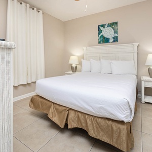 Sleep soundly in this inviting guest bedroom with a plush queen bed, soft linens, and charming coastal artwork