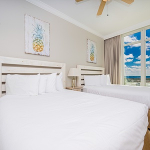 Rest comfortably in this guest room with two queen beds, stylish decor, and stunning beach views