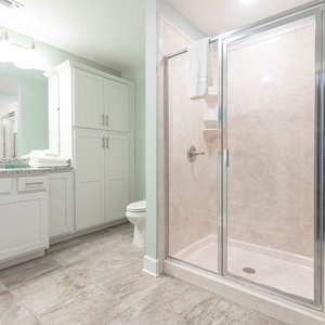 Step into the glass shower for a warm rinse, then dry off with plush towels in this guest bath