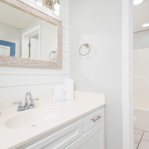 Refresh in the master bathroom featuring a spacious vanity, elegant mirror, and fluffy towels for your comfort