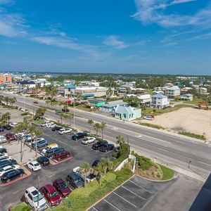 Replenish with views from the balcony overlooking charming coastal homes and vibrant streets in this inviting retreat