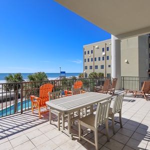 Relax with an outdoor meal on this expansive balcony overlooking the lazy river and waterslide with the beach beyond