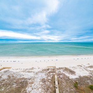 Embrace the calming coast view from your balcony, enjoying the gentle sounds and sights of beach life below
