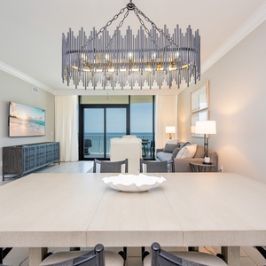 Enjoy stunning beachfront views of the water with a stylish chandelier overhead for family meals or game night