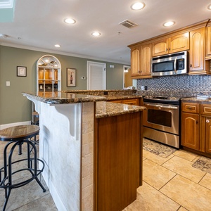 Sleek kitchen with bar seating, stainless appliances, and elegant cabinetry, perfect fo enjoying time together