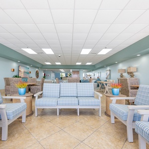 Relax in this inviting lounge with beach views, comfortable seating, and a cozy atmosphere perfect for unwinding