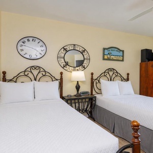 Two twin beds in the guest suite offer plush rests after peaceful afternoons near the shore breeze