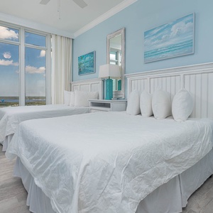 Open the curtains, lie back, and watch the gulf and shore through the tall windows from this queen guest suite