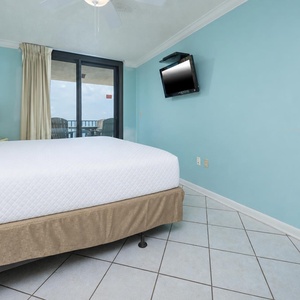 Relax in the tranquil master bedroom featuring a king bed, light decor, and beachfront balcony access