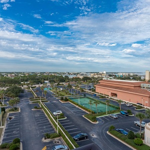 Take in the expansive view of the vibrant surroundings, with tennis courts and lush greenery from the master balcony