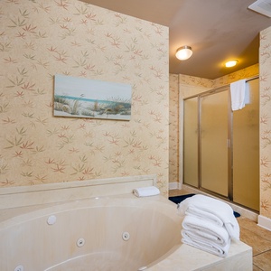 Refresh in the master bath after a day at the beach with a soothing jetted tub and relaxing walk-in shower