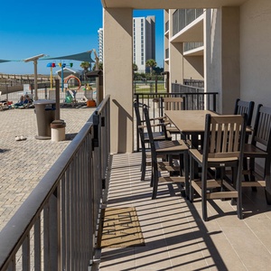 Enjoy dining at the spacious outdoor table, with views of the pool and a refreshing breeze from the beach