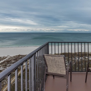 Balcony seating offers a serene view of the tranquil beach and gentle waves, perfect for relaxation and enjoying the scenery