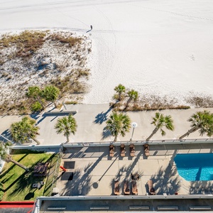 Relax by the poolside under swaying palms, just steps from the beach for a refreshing day in the sun