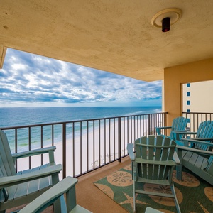 Relax on the turquoise chairs of this balcony, offering breathtaking views of the serene beach and sparkling waters