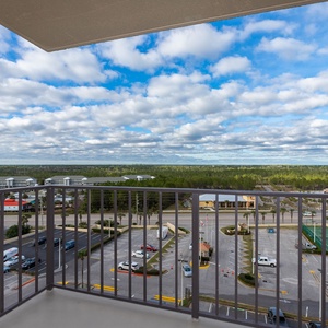 Enjoy breathtaking views of lush greenery and vibrant skies from this inviting balcony from the master