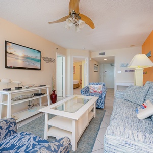 Unwind on plush seating, enjoying family movie nights while gazing at beach decor that enhances your stay