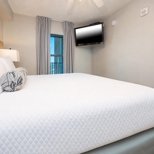 Rest in the comfortable bedroom featuring a plush king bed, soft lighting, and a TV for your entertainment