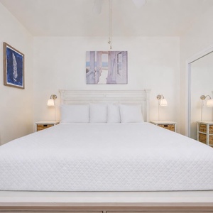 Rest in the master suite where soft lamps glow beside your king bed and calming art soothes your eyes