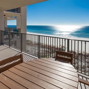 Savor meals at the outdoor patio set while enjoying breathtaking views of the beach from your balcony