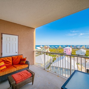 This bright space offers a stunning beach view with palm trees framing the pool area, perfect for relaxation and enjoyment
