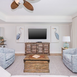 Relax in the comfortable chairs while enjoying the coastal decor and a view of the inviting open living space